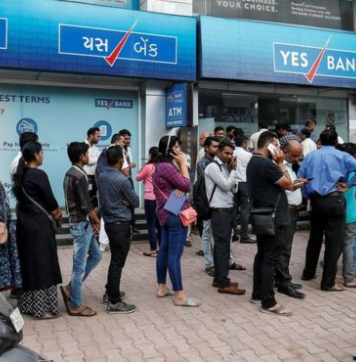 Yes Bank customers queue for cash after India’s central bank takes control