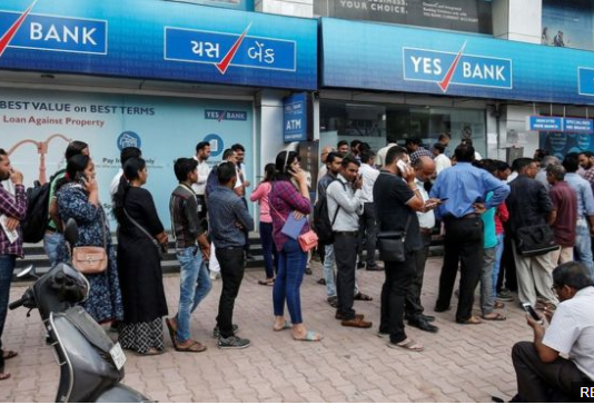 Yes Bank customers queue for cash after India’s central bank takes control